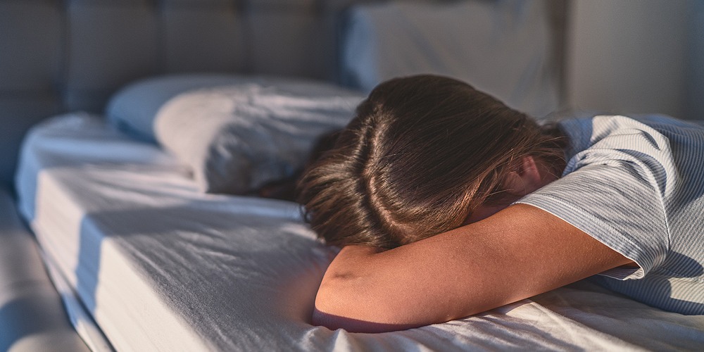 depressed female head down suffering from sleep apnea
