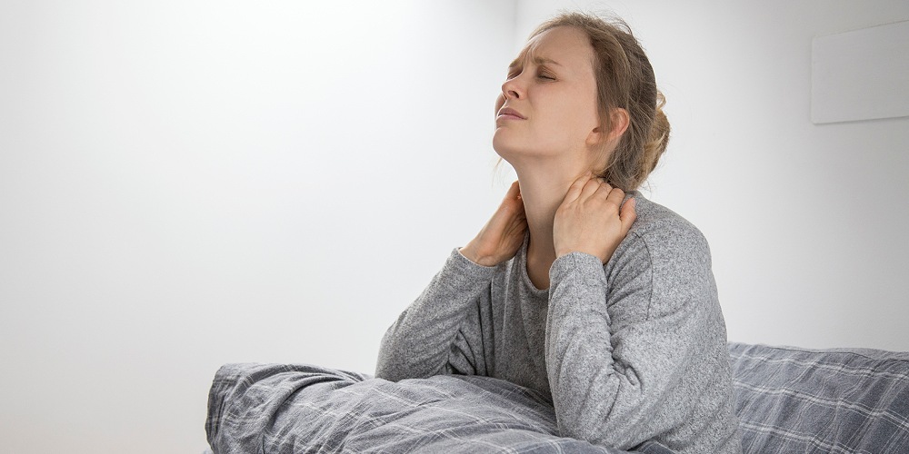 sick woman bed touching her neck suffering from pain